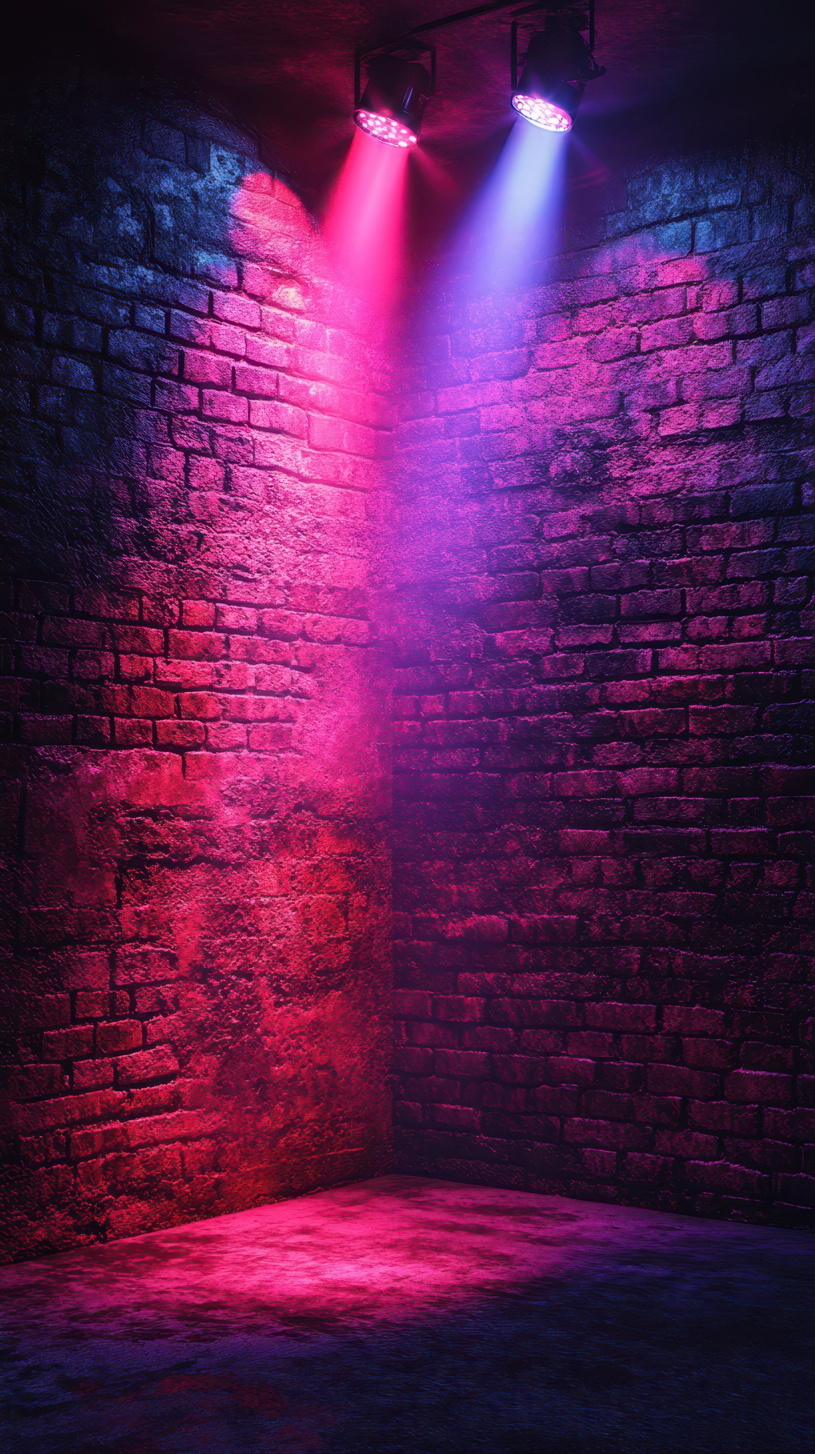 Vibrant colored lights illuminate a textured brick wall in a creative urban space at night